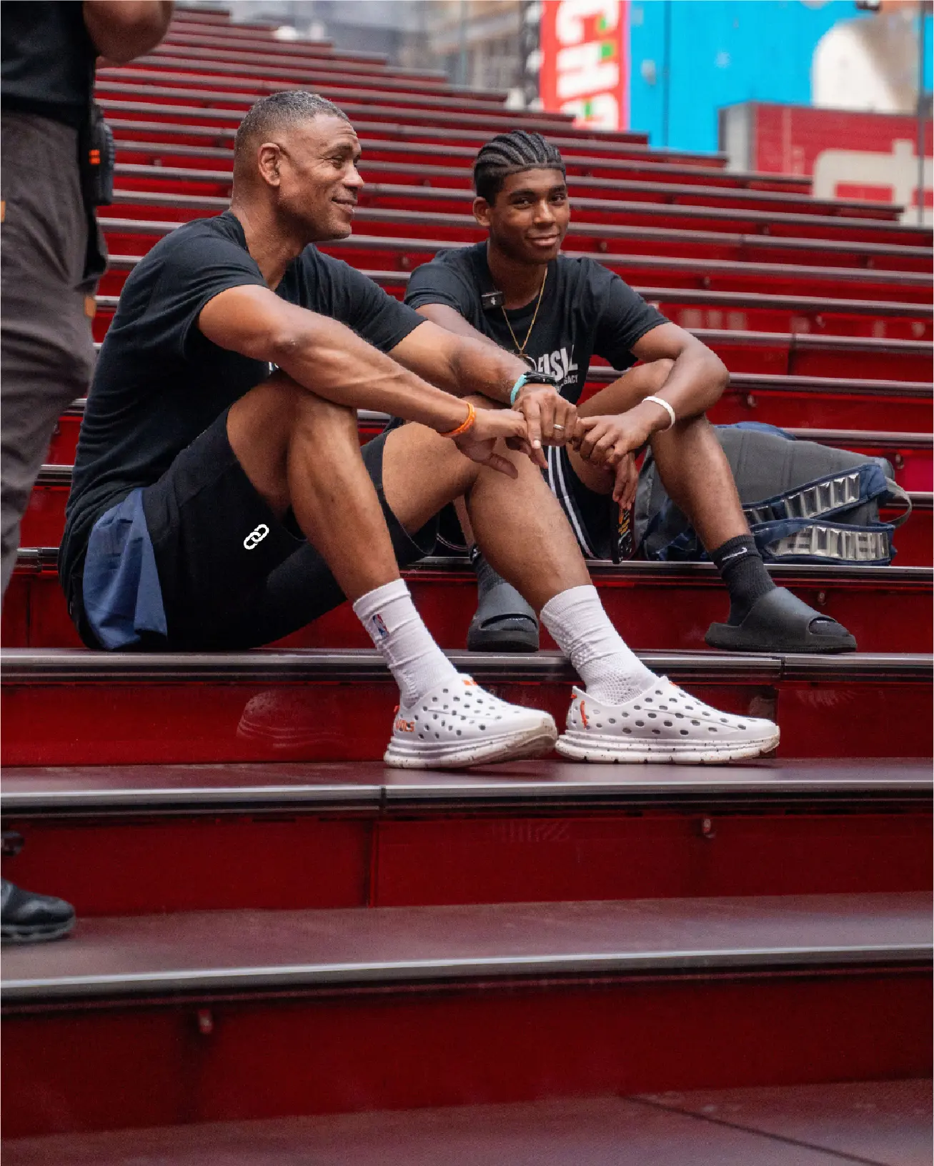 Allan Houston with a young man on red steps
